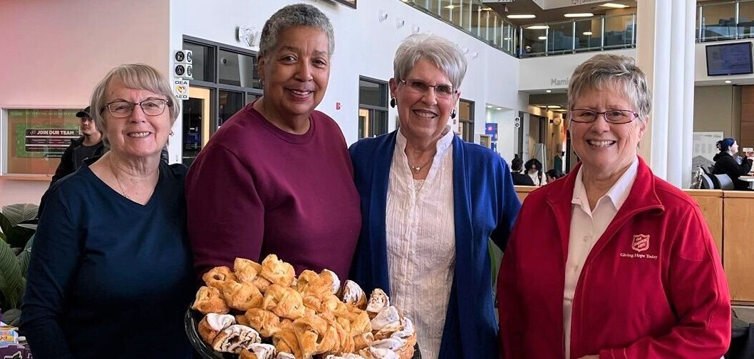 people holding basket of baked goods