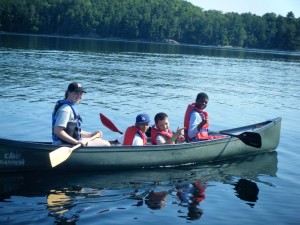 Kids enjoy canoeing on the lake.