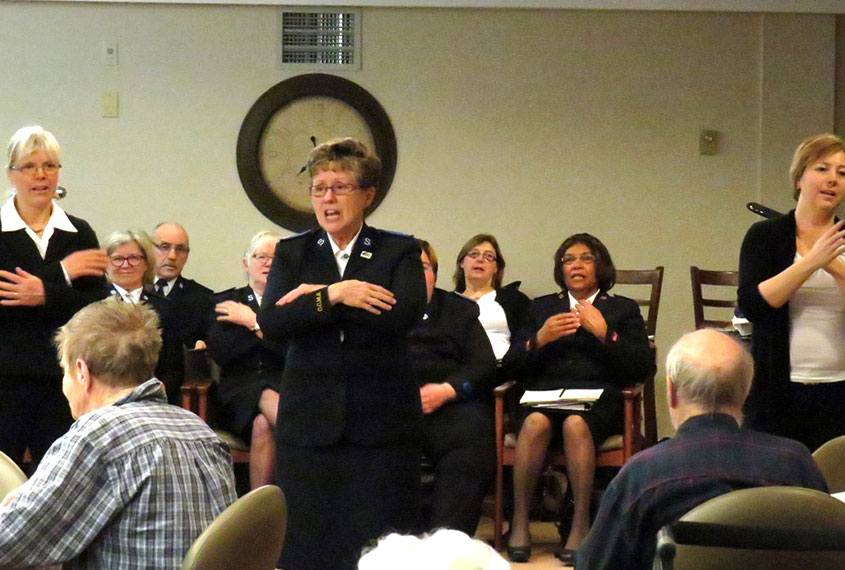 Community Care Ministries team singing with retirement home residents.