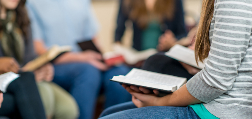 A group of people studying the Bible together.