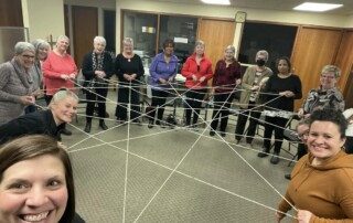 ladies taking part in activity involving string