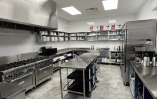 Barrhaven Church's kitchen, with steel countertops and a sink and oven